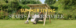 A woman sat in her garden on a swing bench enjoying the sunshine.